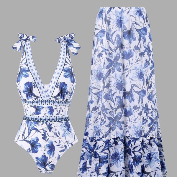 White and green floral print one-piece swimsuit with tie-shoulder straps and matching long chiffon skirt.