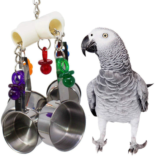Parrot bite toy with four stainless steel cups, colorful plastic pacifier charms, and metal chains, next to an African Grey Parrot.