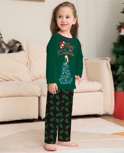 Family of four wearing matching green Christmas pajamas with "Merry Christmas" text and tree graphics. - Image 7