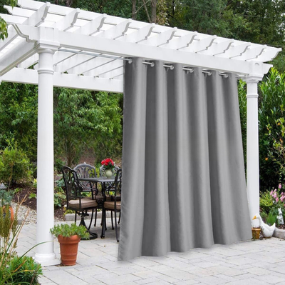 Solid gray outdoor curtain panels with grommet tops hanging from a white pergola on a sunny patio. - Image 15