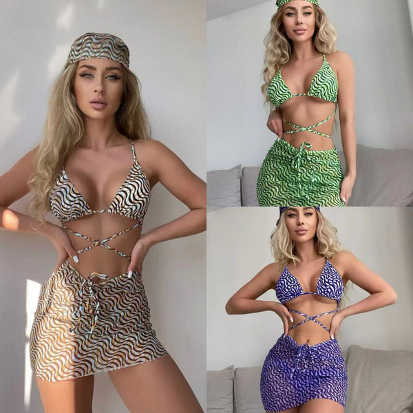 Three-piece swimsuit set with a wavy brown, blue, and white pattern, including a bikini top, mini skirt, and headscarf.