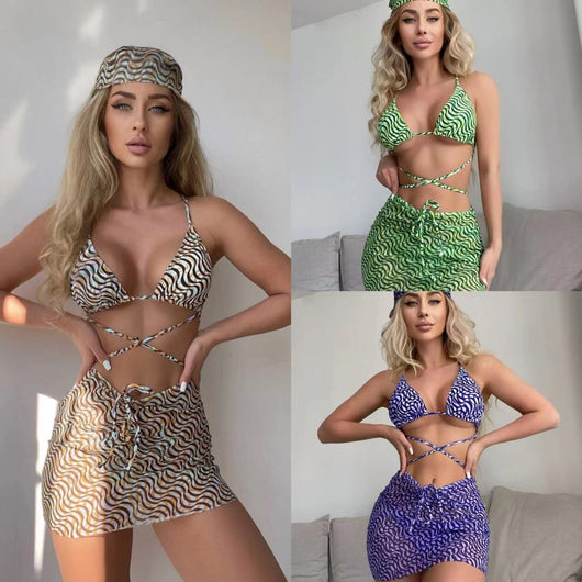 Three-piece swimsuit set with a wavy brown, blue, and white pattern, including a bikini top, mini skirt, and headscarf.