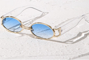 Retro small frame sunglasses with gold round frames and leopard print temples, held by a hand. - Image 5