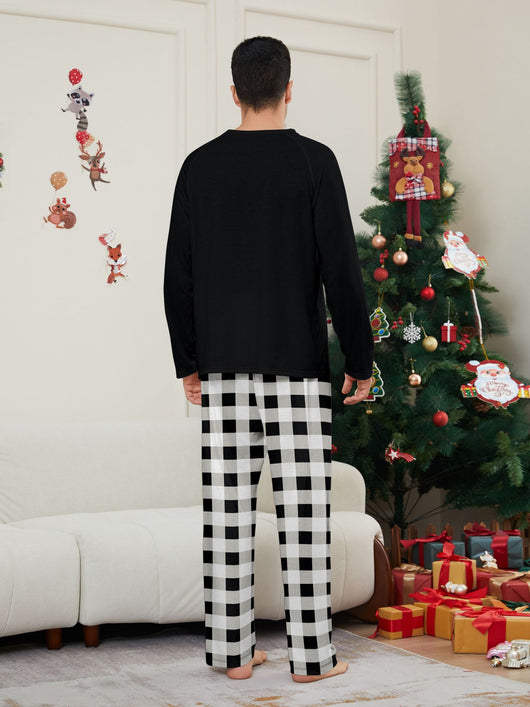Family of four wearing matching black long-sleeve pajamas with "WE ARE FAMILY" text and black and white plaid bottoms. - Image 9