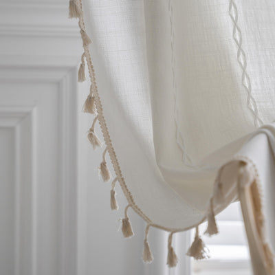 Black polyester curtain with white jacquard multi-line pattern and black tassels, draped over a white chair. - Image 28