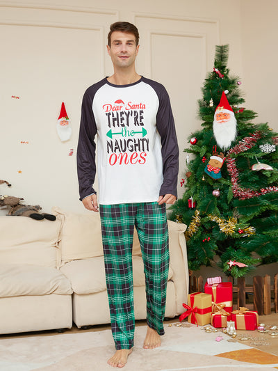 Man wearing a white and black raglan long-sleeve pajama top with a 'Dear Santa They're the Naughty Ones' graphic and green plaid pajama pants. - Image 5