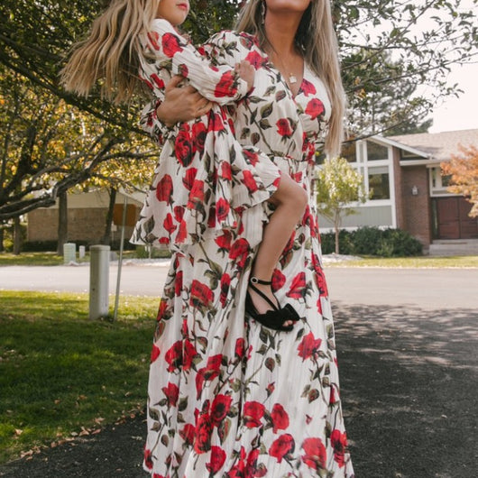 Mother and daughter in matching white dresses with red floral print, V-neck, long sleeves, and tie-waist. - Image 4