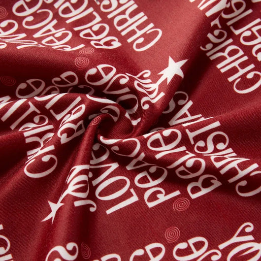 Family of four in matching Christmas pajamas: white tops with red tree graphic, red bottoms with white text. - Image 9