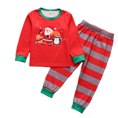 Family of five and pets wearing matching red and grey striped Christmas pajamas with Santa and penguin print. - Image 6