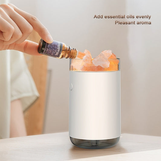 Pink cylindrical humidifier and essential oil diffuser with glowing orange crystal salt stones and a clear base. - Image 2