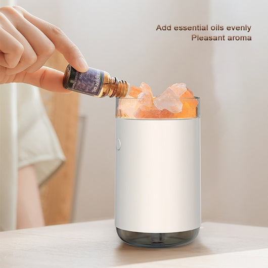 Pink cylindrical humidifier and essential oil diffuser with glowing orange crystal salt stones and a clear base. - Image 2