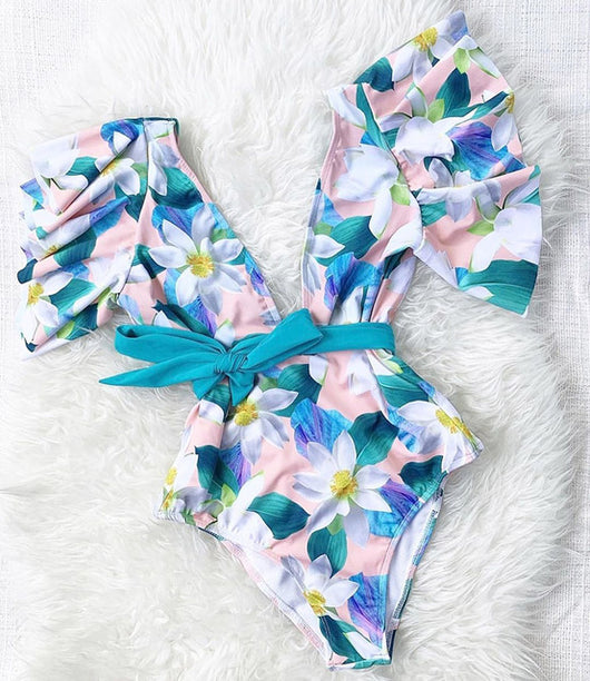 Coral one-piece swimsuit with deep V-neck, ruffled sleeves, and tie-front waist, featuring pink and teal floral print. - Image 12