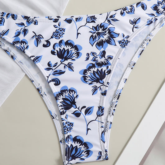 White and yellow floral print three-piece bikini set with a halter triangle top, high-cut bottom, and sheer white sarong. - Image 21