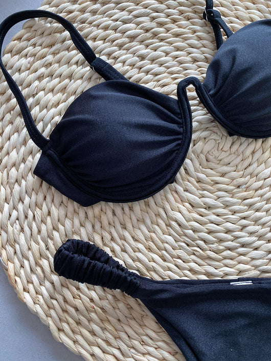 Rust underwire bikini set with ruched top and high-cut bottom, displayed on a woven mat. - Image 12