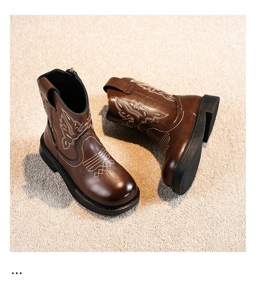 Girls' brown Martin boots with white ethnic embroidery, side zippers, and black soles, displayed on a light carpet. - Image 8