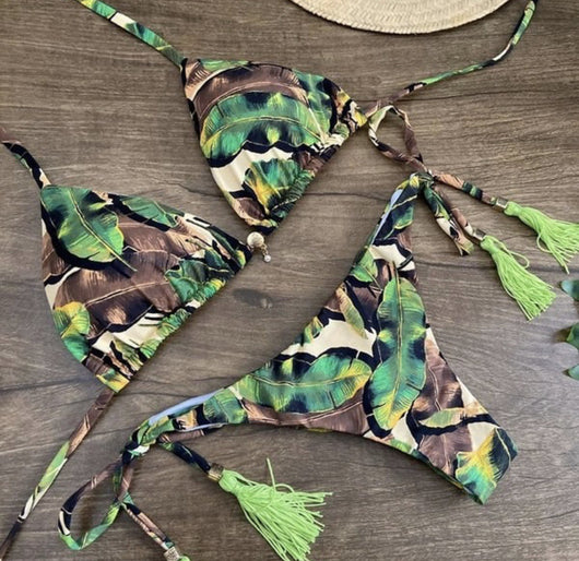 Women's tropical floral print bikini with a halter top, ruffled edges, and tie-side bottoms with pink tassels. - Image 19