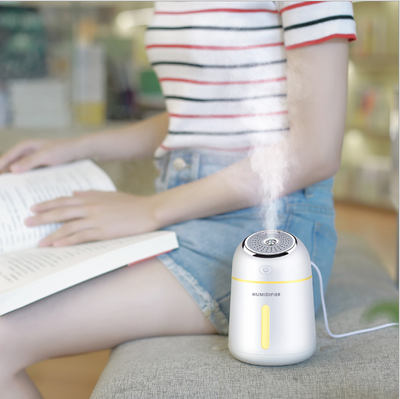 Light blue mini ultrasonic humidifier with a silver top, power button, and clear water level indicator. - Image 3