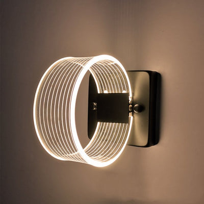 Modern simple LED wall lamp with a curved clear acrylic shade and a metallic base, emitting a warm light. - Image 14