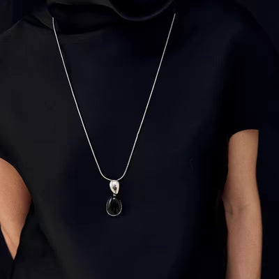Pair of gold-toned irregular earrings with black onyx-like inserts, featuring a modern, abstract design. - Image 25