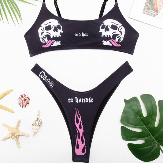 Black bikini swimsuit with white skull and pink flame prints. Top reads 'too hot', bottom reads 'to handle' with 'MISS' and a skull.