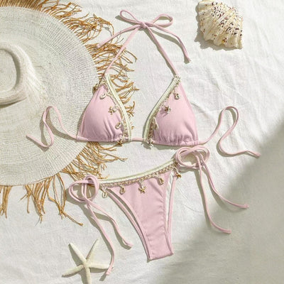 Light pink ribbed halterneck bikini with triangle cups and tie-side bottom, adorned with shell and starfish charms. - Image 3