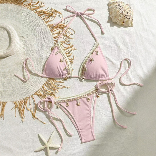 Light pink ribbed halterneck bikini with triangle cups and tie-side bottom, adorned with shell and starfish charms. - Image 3