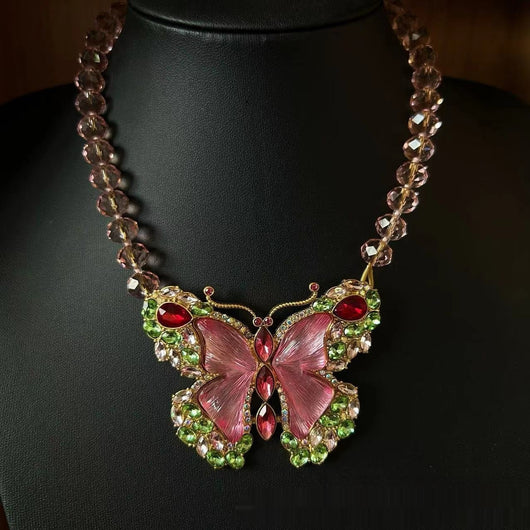 Pink enamel butterfly brooch with green, red, and clear rhinestones set in gold-toned metal. - Image 6
