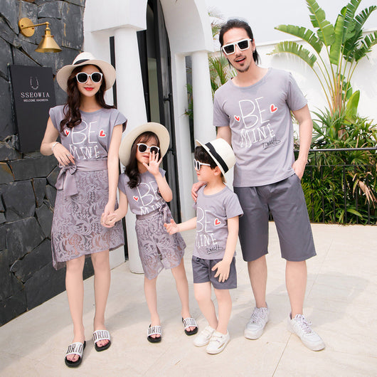 Family of four in matching grey "BE MINE" outfits. Mother and daughter wear lace skirts, father and son wear shorts. - Image 10