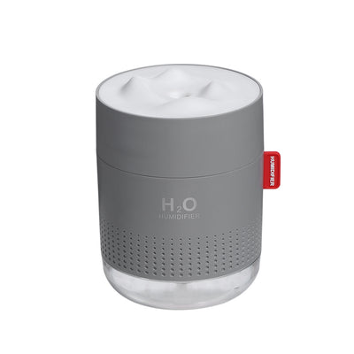 White cylindrical USB charging desktop humidifier with a clear base and a textured snow mountain top. Features 'H₂O HUMIDIFIER' text and a red tag. - Image 5