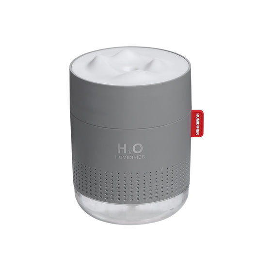 White cylindrical USB charging desktop humidifier with a clear base and a textured snow mountain top. Features 'H₂O HUMIDIFIER' text and a red tag. - Image 5
