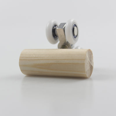 Wooden bird toy resembling a roller skate with a pine log body and four white wheels with metal bearings. - Image 2