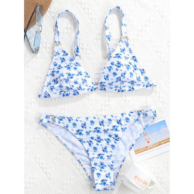 Woman smiling in a white bikini with blue floral print, triangle top, and briefs bottoms, on a sunny beach. - Image 45