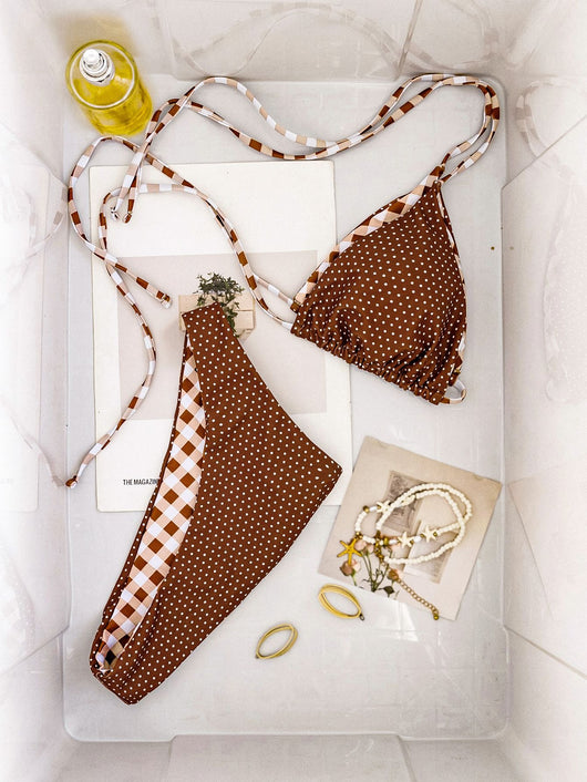 Retro brown and white plaid triangle bikini top with matching polka-dot bottoms, displayed flat with accessories. - Image 13