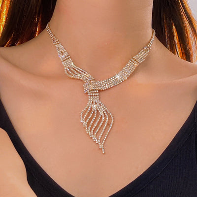Gold-tone rhinestone necklace and matching dangle earrings set. The necklace features a multi-strand, leaf-like design. - Image 12