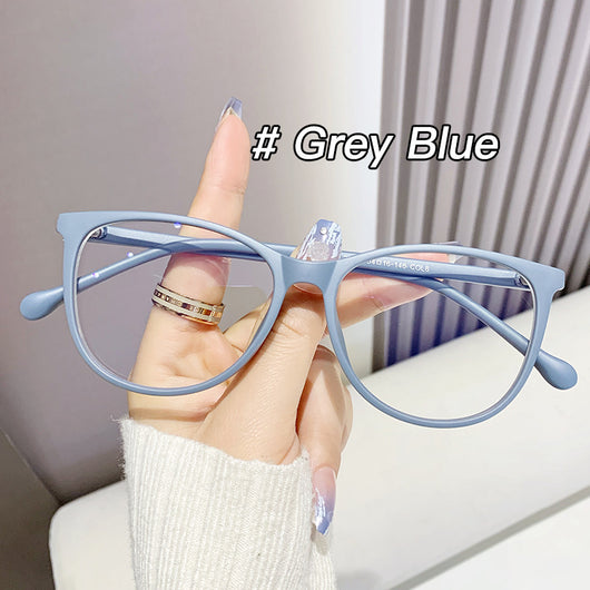 Black full-frame round anti-blue light glasses held by a hand with a gold ring and light blue gradient nails. - Image 12