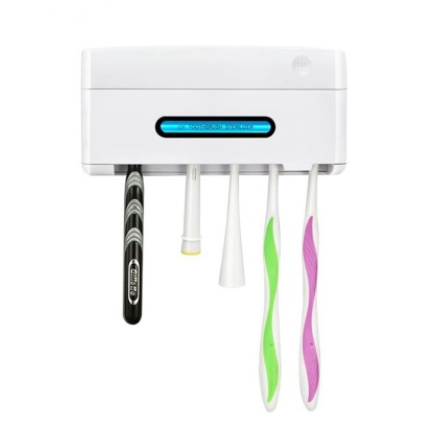 Mint green UV toothbrush sterilizer holder with a 'START' button and a display showing 'UV TOOTHBRUSH STERILIZER'.