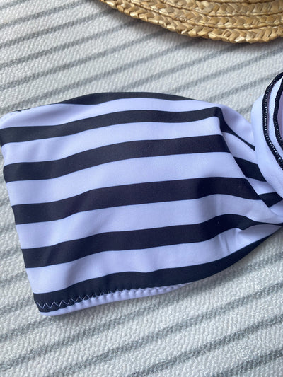 Black tube top bikini with white three-dimensional flower embellishments, worn by a woman partially submerged in water. - Image 18
