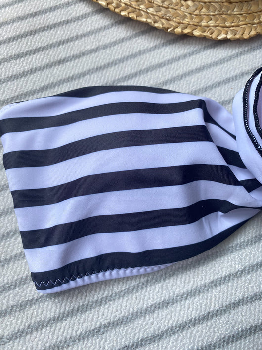 Black tube top bikini with white three-dimensional flower embellishments, worn by a woman partially submerged in water. - Image 18