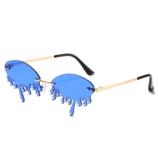 Rimless sunglasses with dark gray dripping liquid-shaped lenses, silver studs, and gold metal frames. - Image 19