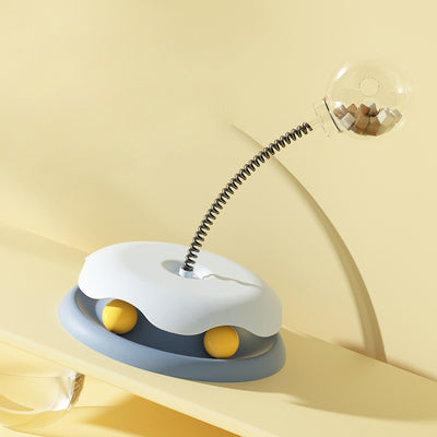 Mint green and dark green cat leakage food toy with a clear spherical treat dispenser on a black spring. - Image 15