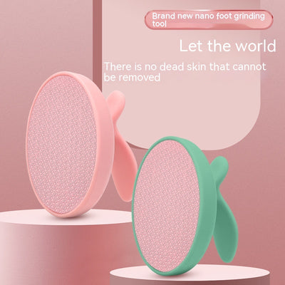 Pink oval nano foot grinder with a textured surface and ergonomic handle, designed for exfoliating and removing calluses.