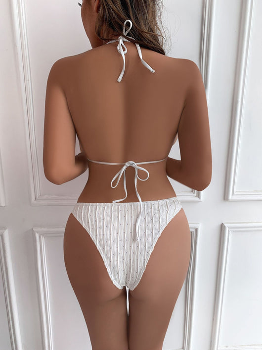 White textured bikini with ruched triangle top, high-cut bottom, and matching sarong with a large bow. - Image 18