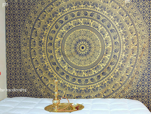 Gold and blue mandala tapestry with elephant and floral patterns, hung above a white quilted bed. - Image 2