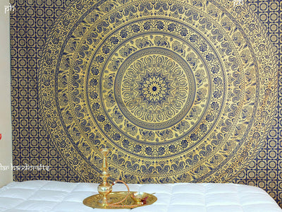 Gold and blue mandala tapestry with elephant and floral patterns, hung above a white quilted bed. - Image 2