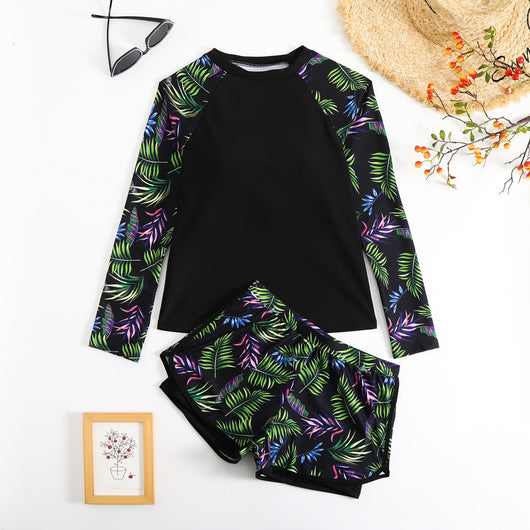 Women's long-sleeve tankini swimsuit with black top and blue tropical leaf print raglan sleeves, matching swim shorts. - Image 4