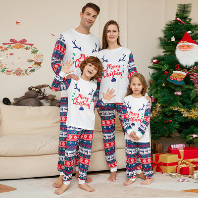 Family of four wearing matching white and red/blue Christmas pajamas with reindeer antlers and 'Merry Christmas' text. - Image 6