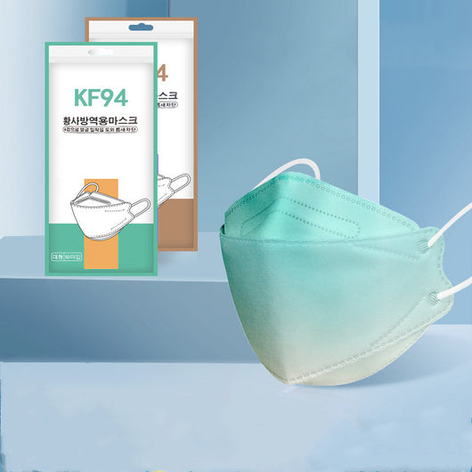 Pink gradient KF94 mask with white ear loops, displayed next to its packaging on a blue background. - Image 12