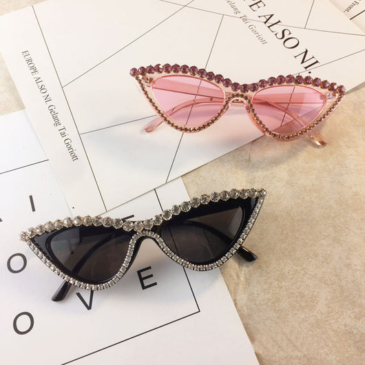 Two pairs of cat-eye sunglasses, one black with clear rhinestones and one pink with pink rhinestones, on a light surface. - Image 5