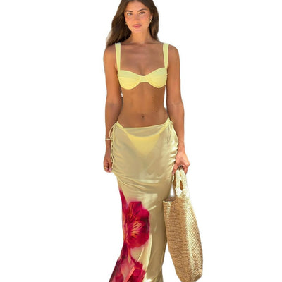 Woman in a light yellow three-piece bikini with an underwire top, matching bottoms, and a sheer floral sarong skirt. - Image 5