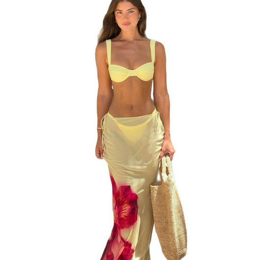 Woman in a light yellow three-piece bikini with an underwire top, matching bottoms, and a sheer floral sarong skirt. - Image 5